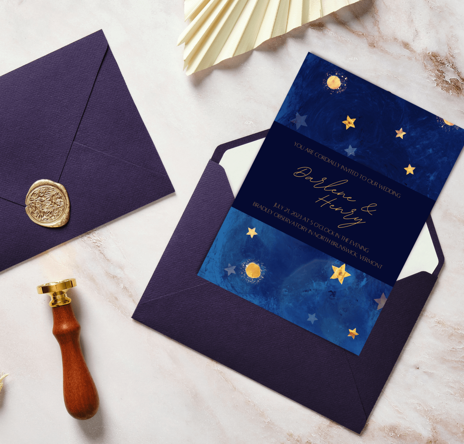 celestial wedding invitation laying flat on a marble surface